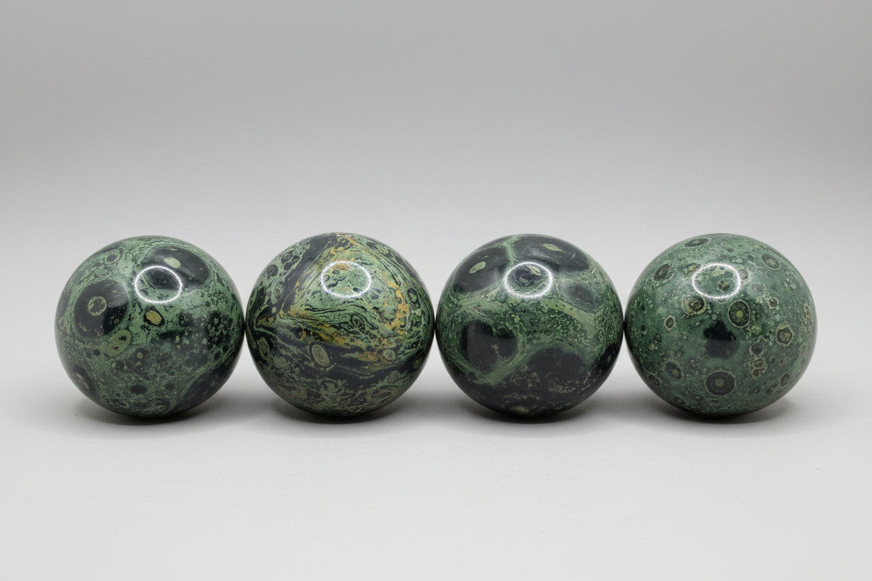 Four marbled stones on grass with white circles drawn around them