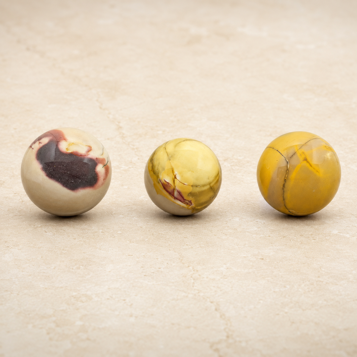 Three polished 5 cm Australian Mookaite crystal spheres