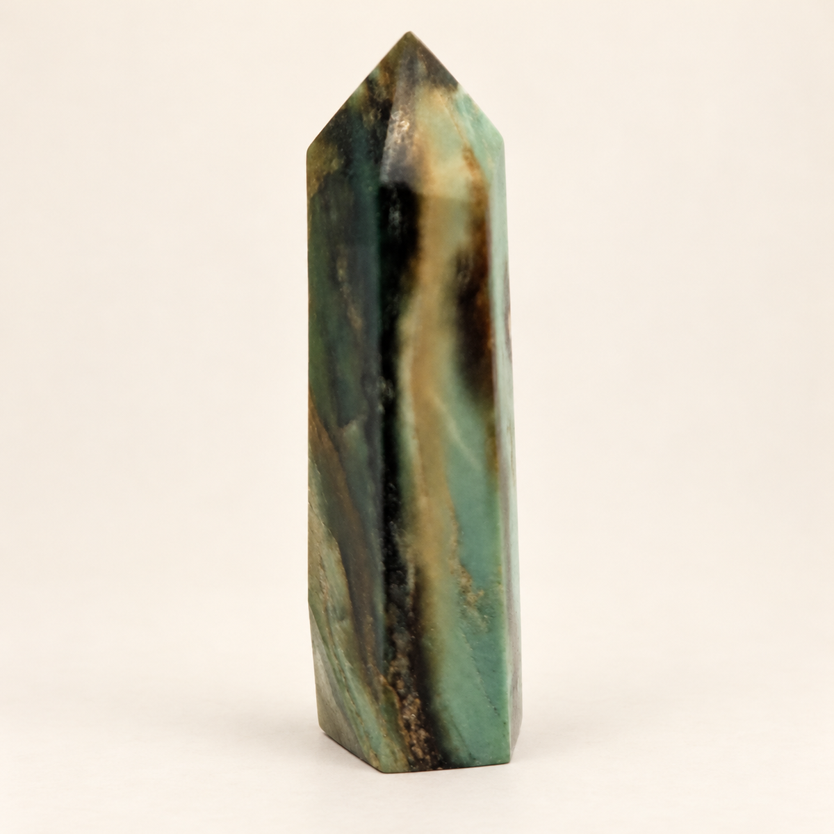 9 cm Chinese Emerald Tower with green, cream and dark vertical markings against an ivory background