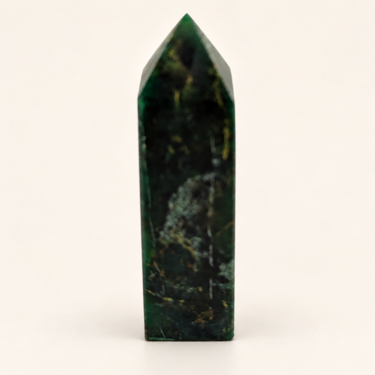 10 cm dark green Chinese Emerald Tower with lighter mottled markings against an ivory background