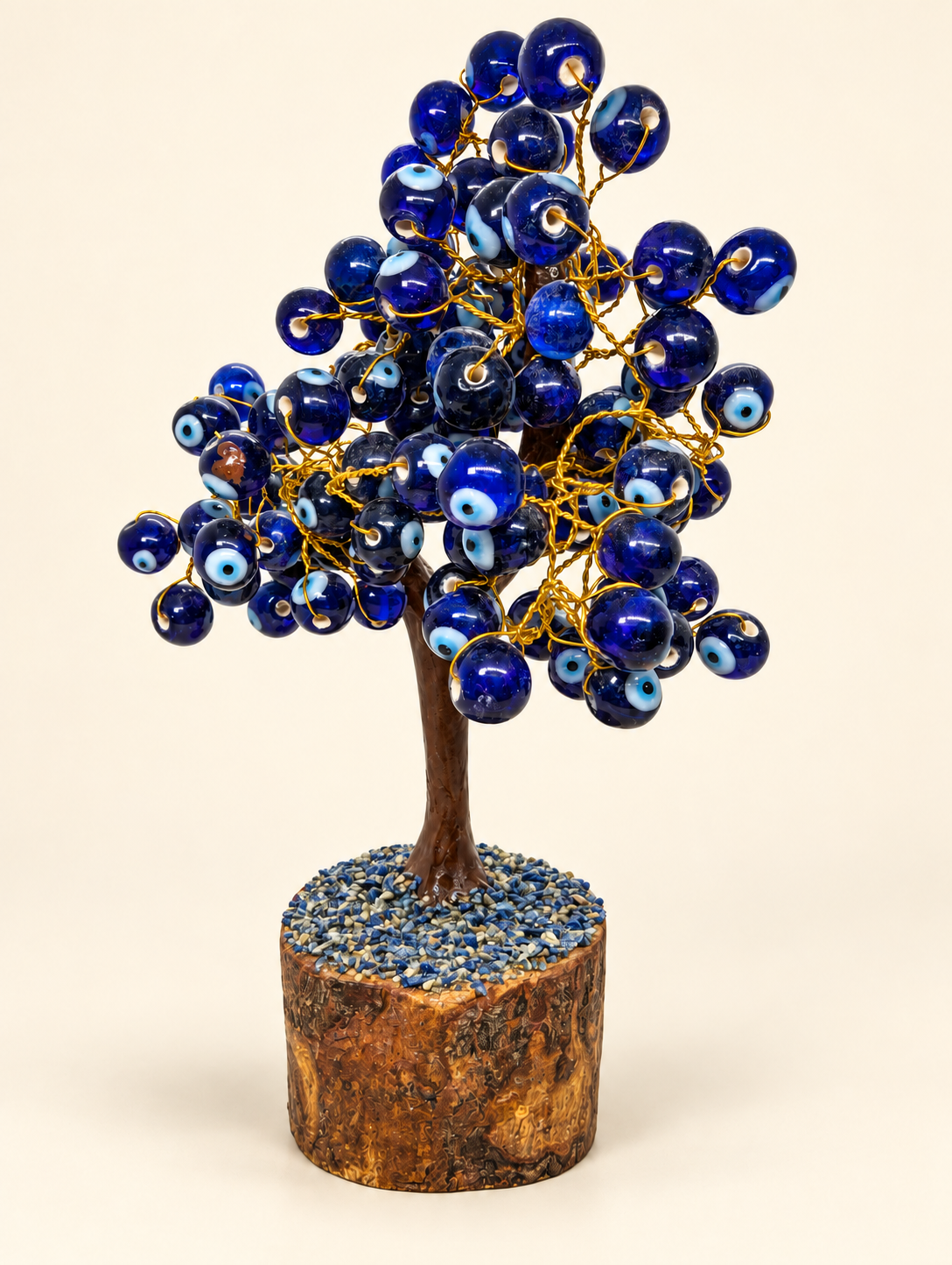 Large handmade blue evil eye tree on a cream background