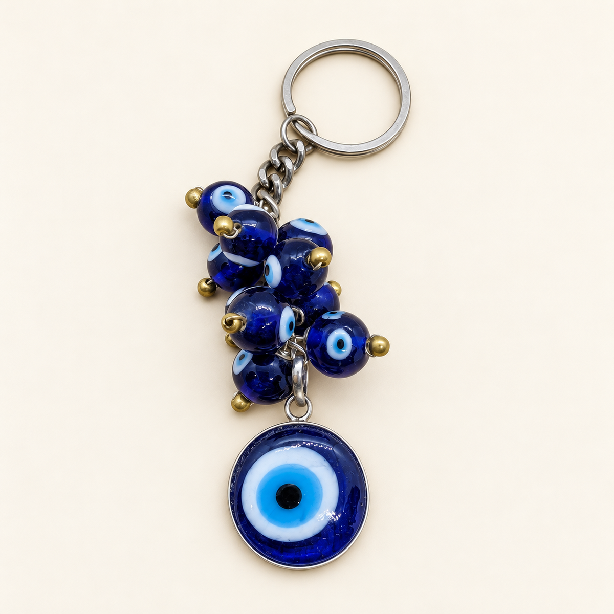 Turkish eye keyring with clustered blue eye beads, gold-coloured bead ends and a large round eye charm on a silver-coloured chain and key ring